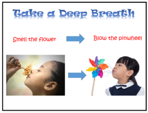 child smelling flower and blowing a pinwheel