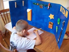 Boy sitting at table with visual boundary 